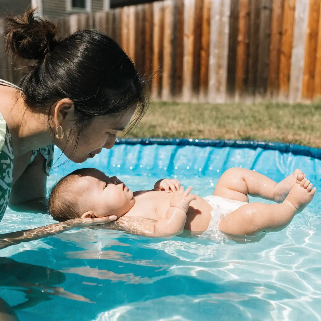 Parent holding baby in a swimming pool