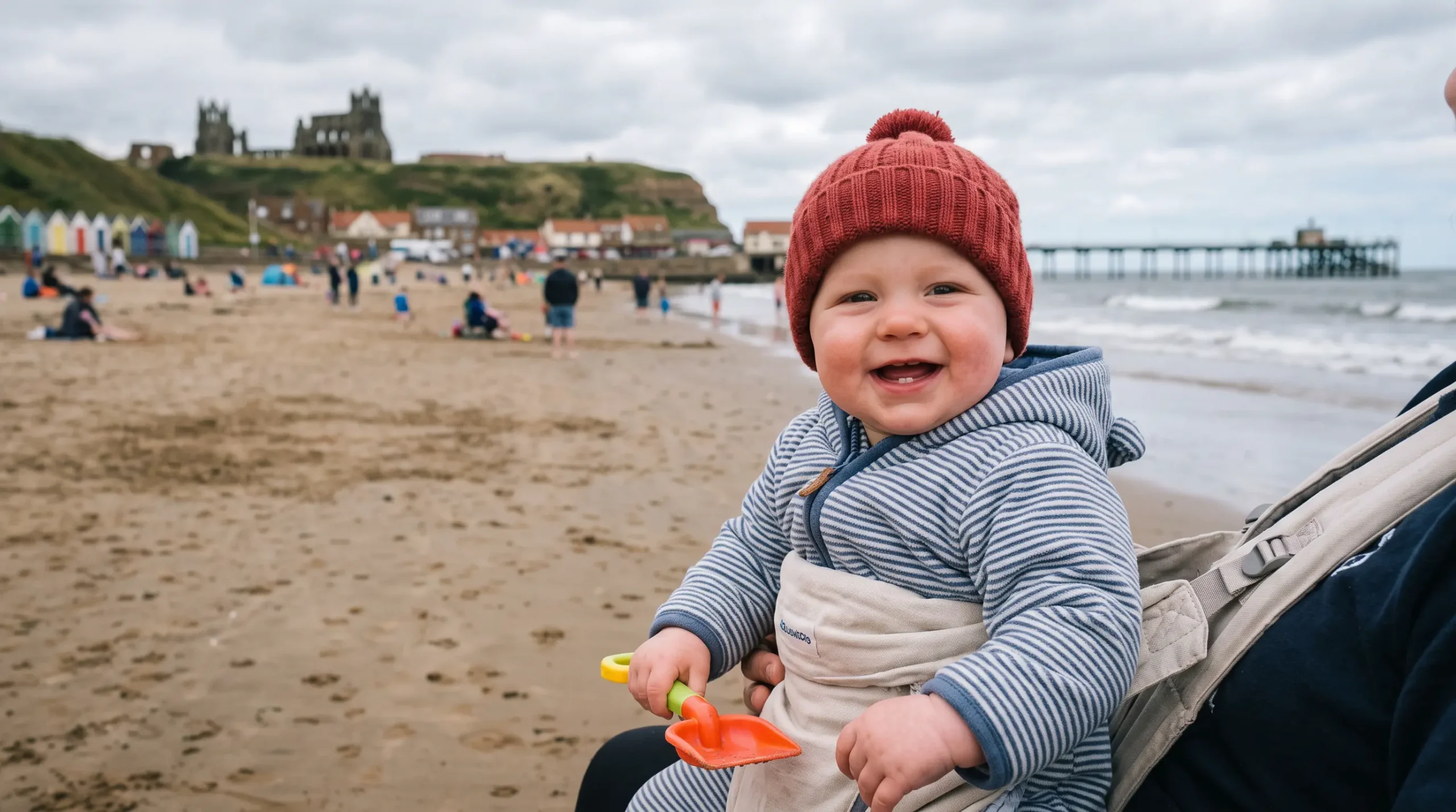 Family with a baby on a UK holiday by the coast