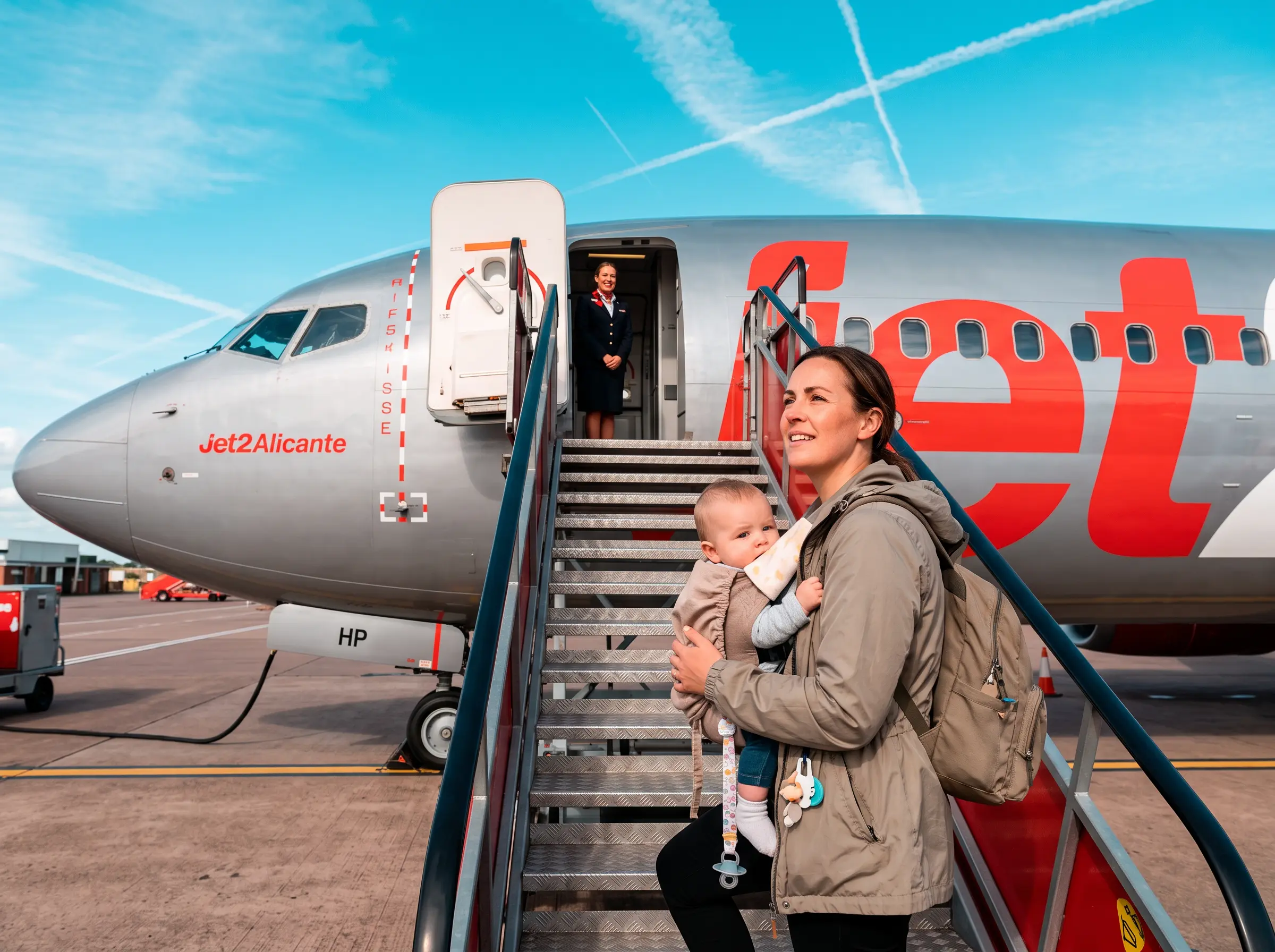 Parent boarding a Jet2 flight with a baby