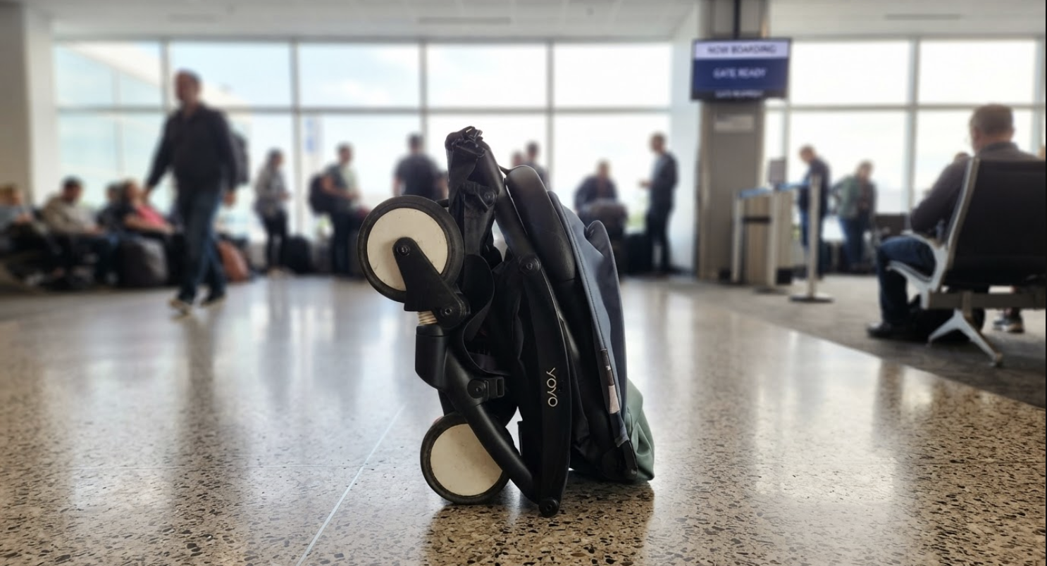 Parent folding a stroller at the airport gate before boarding