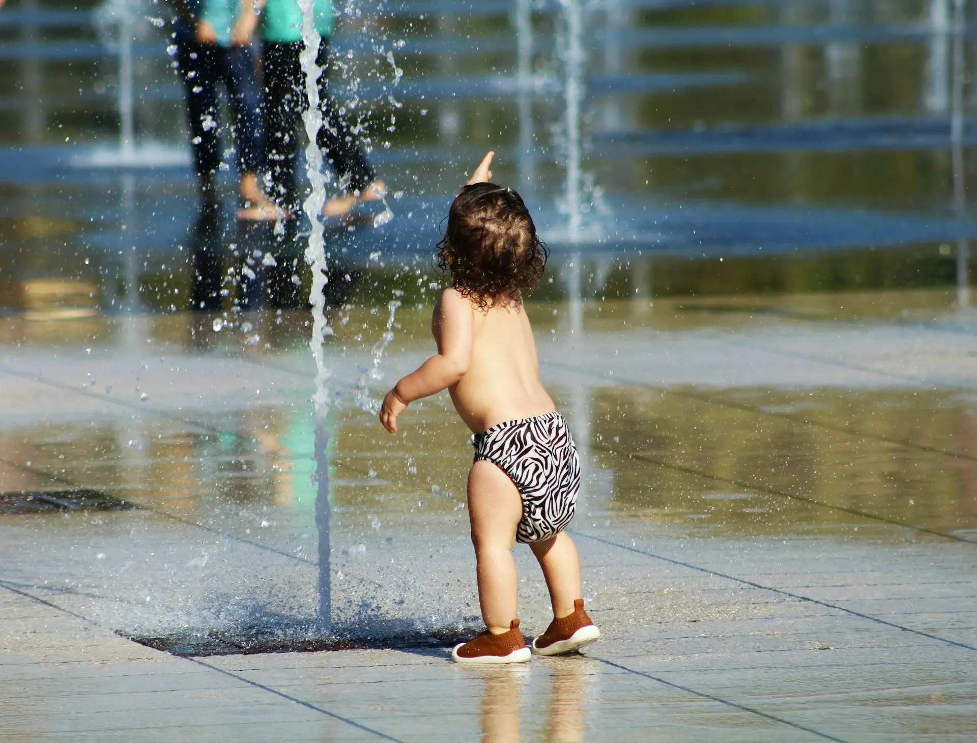 Toddler being watched closely by a parent after swimming